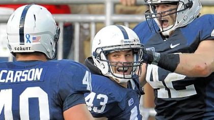 Penn State linebacker Mike Hull, middle, celebrates after returning a fumble 74 yards for a touchdown in the fourth quarter of the Nittany Lions' 34-7 win against Navy Saturday at Beaver Stadium.