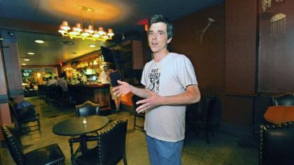 Trevett Hooper stands in the empty space that would serve as the bandstand at Legume in Oakland.  Mr. Hooper is just one of many restaurant owners who have elected not to hire live musicians to avoid paying steep licensing fees.