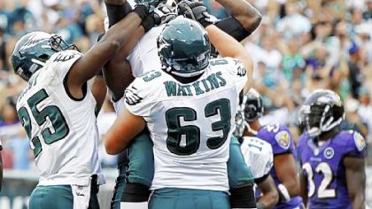 The Eagles' LeSean McCoy, Michael Vick and Danny Watkins celebrate after Vick's rushing touchdown in the fourth quarter against the Ravens Sunday in Philadelphia.
