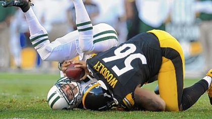 Steelers linebacker LaMarr Woodley sacks Jets quarterback Mark Sanchez.
