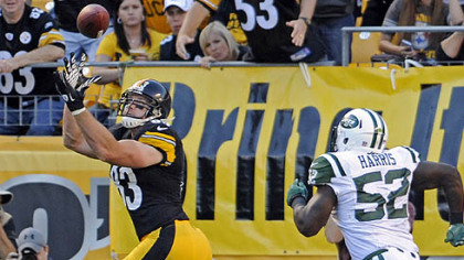 Heath Miller pulls in a pass for a touchdown as he's defended by the Jets' David Harris in the second quarter at Heinz Field Sunday.