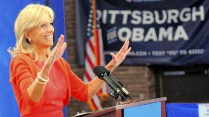 Jill Biden, wife of Vice President Joe Biden, gestures for the audience to take their seats for her talk at a Women for Obama campaign event.
