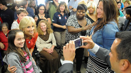 Jill Biden poses for a photo with Mairyn McFall, 9, of Murrysville following Ms. Biden's talk at a Women for Obama campaign event at the Obama campaign office in the Strip District.