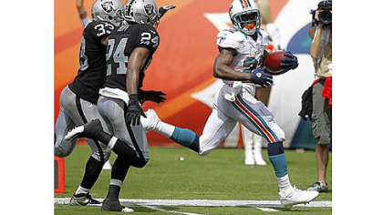 The Dolphins' Reggie Bush runs for one of his two TDs Sunday.