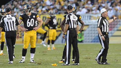 The Steelers' Greg Warren watches the referees as they decide a call against his team in the fourth quarter at Heinz Field Sunday.