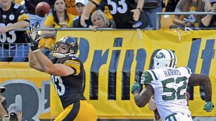 The Steelers' Heath Miller pulls in a pass for a touchdown as he's defended by tghe Jets' David Harris in the second quarter at Heinz Field Sunday.