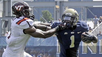 Pitt's Ray Graham plants a stiff arm to the face of Virginia Tech's Antone Exum in the second quarter Saturday at Heinz Field.