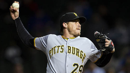 Pirates' pitcher Kevin Correia picked up his 11th win while pitching seven scoreless innings in the rain-delayed victory Monday night over the Cubs.
