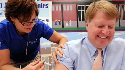 Allegheny County Executive Rich Fitzgerald gets a flu shot from Kim Delp at an influenza and vaccination educational event today.