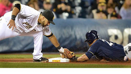 Pirates third baseman Pedro Alvarez tags out the Brewers' Carlos Gomez as he was caught stealing.