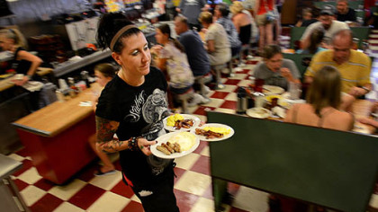 Lori Robinson serves up breakfast at DeLuca's in the Strip District.