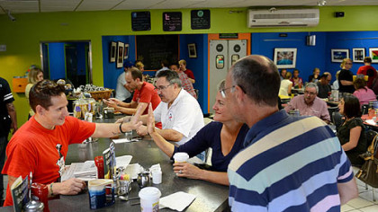 Jason Knapton talks with customers Jane Johnson and Bob Roberson, both of Regent Square, at the Square Cafe.