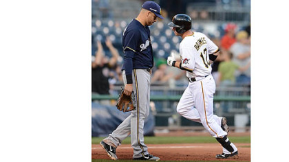 Pirates' Clint Barmes passes by Brewers' Aramis Ramirez after hitting homer to break the tie in the 4th inning