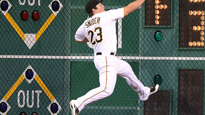 Pirates right fielder Travis Snider crashes in to the right field wall on double hit by the Brewers' Norichika Aoki scoring the go ahead runs.