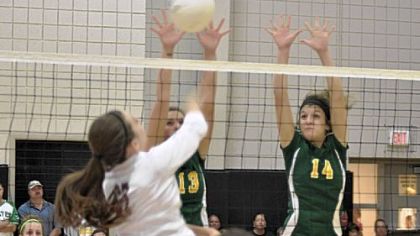 Blackhawk's Hannah Pringle (13) and Nikki Beatty (14) block against Uniontown at the Upper St. Clair Tournament.