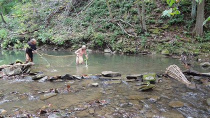 Doug Wood and Aaron Bosnick demonstrate prehistoric net fishing at Meadowcroft Museum.