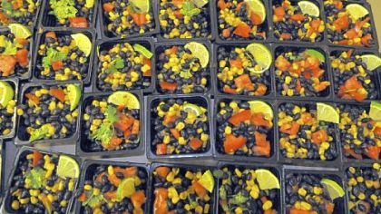 A closeup of the black bean corn salsa with sliced lime on top.