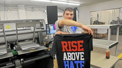 Mike Connors displays a shirt that had just come out of a digital direct department printer at Spreadshirt.com.