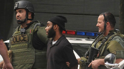 Police lead suspect Klein Michael Thaxton out of Three Gateway Center in Downtown Pittsburgh, where they say he held a man hostage for several hours today.