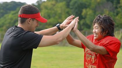 Dil Subba, 16, from Nepal, high-fives his football coach T.J. Wiley Monday during practice at Northgate High School in Bellevue.