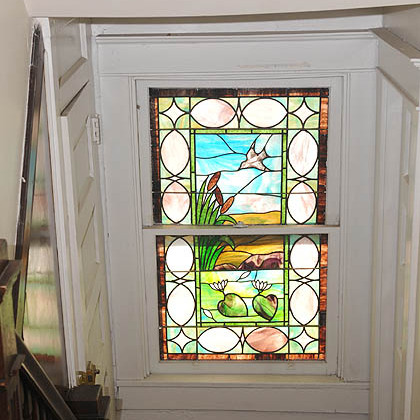 A stain glass window in the stairwell