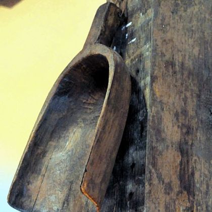 A wooden scoop hangs on a post in the kitchen of the Wise home.