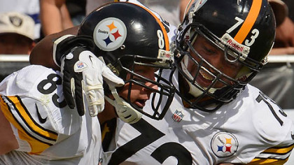 The Steelers Heath Miller, left, celebrates his second touchdown of the game with Ramon Foster in the first half against the Raiders.