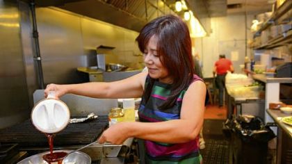 Ling Robinson prepares Queen Tilapia at the Green Mango in Monroeville.