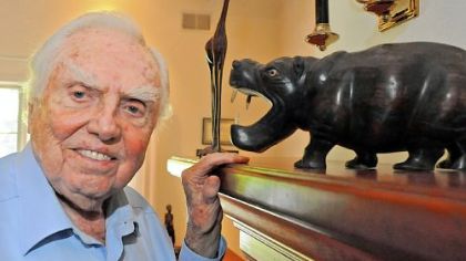Aubrey Briggs'  home office is decorated by the gifts of mahogany sculptures he's received.
