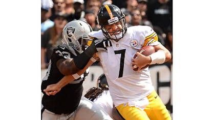 Steelers quarterback Ben Roethlisberger is hauled down by the Raiders' Lamarr Houston in the fourth quarter.