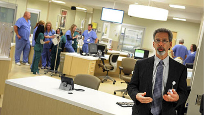 Jeffrey Alvarez, RN Director at UPMC East near the intersection of Business Rt. 22 & Rt. 48 in Monroeville talks with the media about the new emergency room while workers prepare for the July 2, 2012 opening.