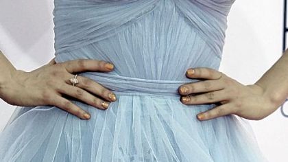 Zooey Deschanel displays her manicure. This year's red carpet had a mani-cam so that actresses could show off their manicures.