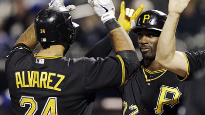 The Pirates' Andrew McCutchen, right, greets Pedro Alvarez at home plate after scoring on Alvarez's first-inning, three-run home run.