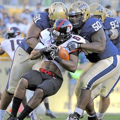Pitt''s Darryl Render and Tyrone Ezell take down Gardner-Webb''s Kenny Little in the third quarter Saturday at Heinz Field.