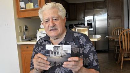 James Roberto, 88, holds a photo of the "little white house" he lived in on Marion Street in Uptown for more than 40 years before he sold it to UPMC Mercy. Mr. Roberto, who had rejected several offers from Mercy Hospital, sold the property to UPMC for $573,847.