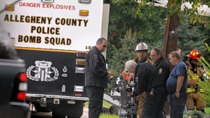 The bomb squad robot is readied to enter a residence on New York Circle in Bridgeville, before a man was found dead in an elaborate suicide.