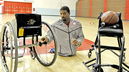 Trevon Jenifer, a 24-year-old graduate of Edinboro University, switches the wheels from his everyday wheelchair to the one he uses for basketball. The game chairs are custom-built to regulation specifications for each player depending on their size and style of play.