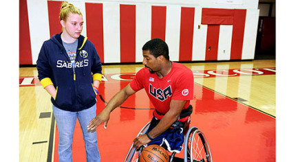 Trevon Jenifer explains game strategy to his girlfriend of nearly four years, Laura Klass.