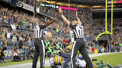 Wide receiver Golden Tate of the Seahawks makes a catch in the end zone to defeat the Packers on a controversial call by the officials.