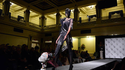 A model wears accessories and refuse-inspired appparel by Faith Pongracz of Faith n' Khaos as a commentary on consumption in society.