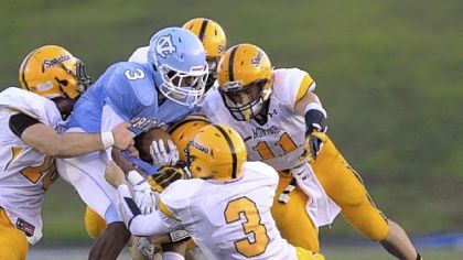 Central Valley's Jordan Whitehead, being gang-tackled by Montour defenders, leads the Warriors rushing attack.