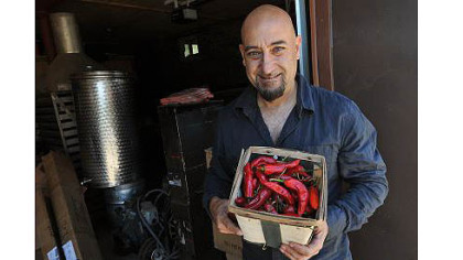 Nick DiCio of Reyna Foods displays a basket of chiles grown locally from Hatch seed.
