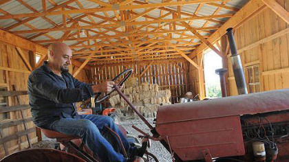 Nick DiCio fires up an antique tractor that will be used to pull a wagon for hayrides at the first annual Pepper Farm Festival.