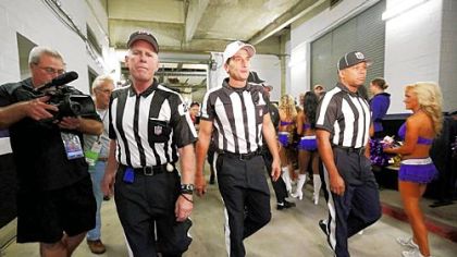 From left, officials Bob Waggoner, Gene Steratore of Washington, Pa., and Wayne Mackie, walk toward the field before Thursday's game between the host Baltimore Ravens and Cleveland Browns.