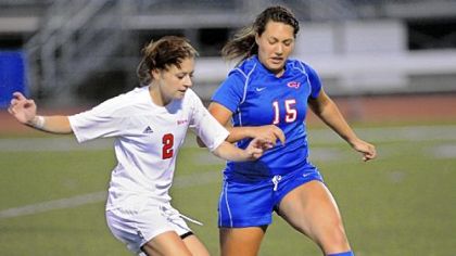 Peters Township midfielder Nicole Hume, left, fights for possession with Chartiers Valley defender Alanna Sullivan Sept. 19.