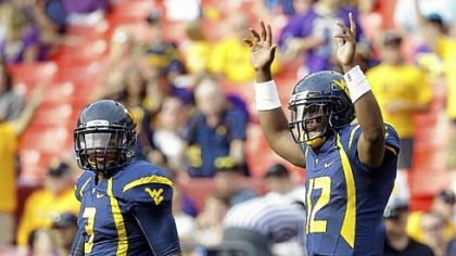 West Virginia quarterback Geno Smith, right, reacts after a touchdown pass to wide receiver Stedman Bailey in the first half Sept. 15 against James Madison in Landover, Md.