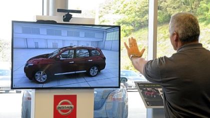 Gary Carr, general manager of Pittsburgh East Nissan, demonstrates the Pathfinder Kinect Experience in the showroom.