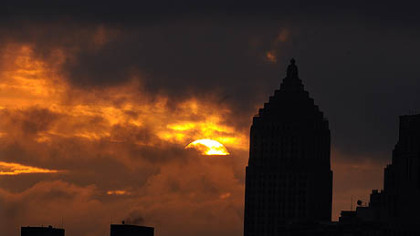 The sun makes a brief appearance early Friday through the low clouds and fog with the Gulf Tower in the forground.