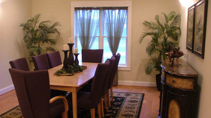 The dining room at Park Place - Cranberry has Craftsman-style trim and crown molding.