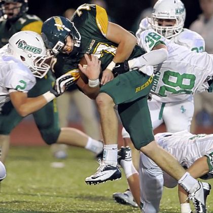 Seton-LaSalle quarterback Luke Brumbaugh is taken down by South Fayette''s Dylan Opar and Dylan Nock Friday night.
